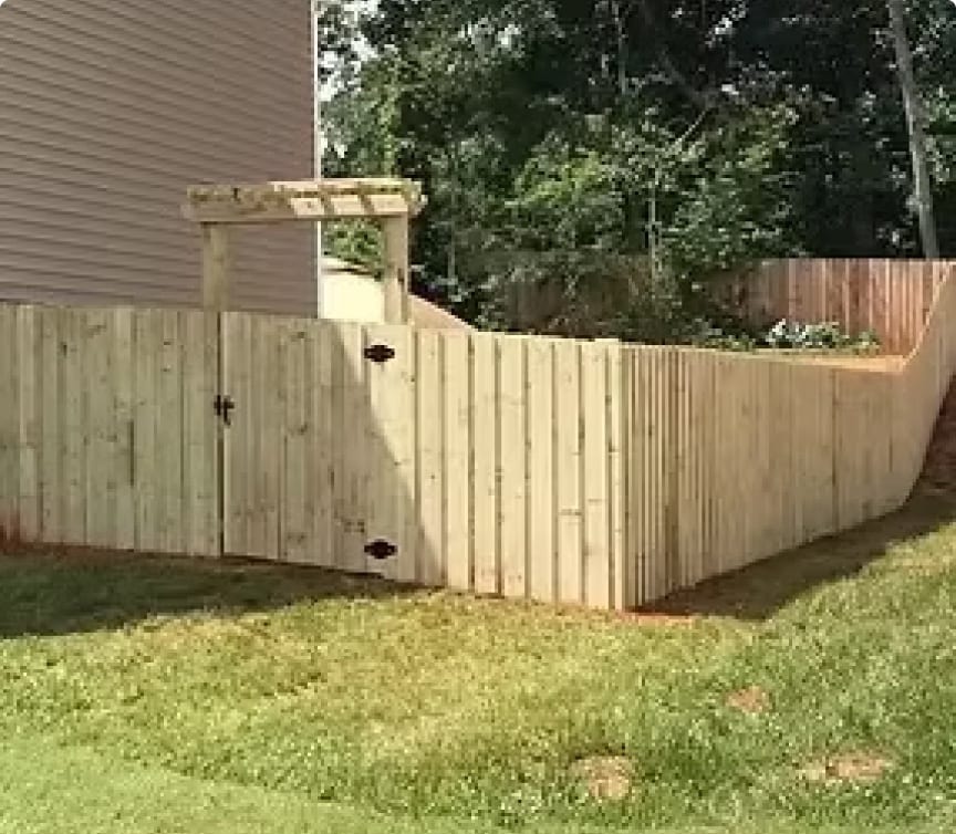 Cedar wood privacy fence with an arbor gate in an Apex, NC backyard